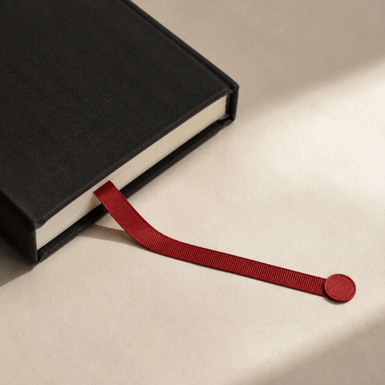 A red bookmark extending from an unbranded book into a progress marker